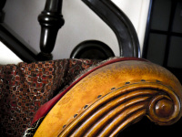the ligth brown armrest of an old sofa in leather and wood in the lounge of the hotel elafos on rhodes