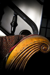 the ligth brown armrest of an old sofa in leather and wood in the lounge of the hotel elafos on rhodes