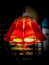 a unique lamp, builded by bottles of campari, in a italian restaurant in cologne