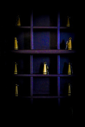 in a wooden purple key rack are golden colored keys for the rooms in the elafos hotel on rhodes