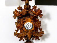 a light brown wooden cuckoo clock with the head of a deer in the elafos hotel on rhodes