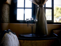 a stylish sitting area with armchairs in front of a window in the elafos hotel on rhodes