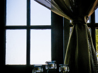 an airy curtain in front of a window in the lounge of the elafos hotel on rhodes