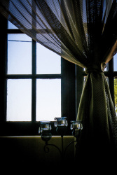 an airy curtain in front of a window in the lounge of the elafos hotel on rhodes
