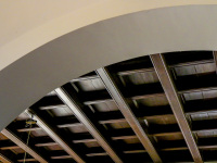 a round arch and a dark brown wooden ceiling in the lounge in the elafos hotel on rhodes