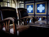 leather armchairs with wooden armrests and a wooden table in the lounge of the elafos hotel on rhodes