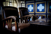 leather armchairs with wooden armrests and a wooden table in the lounge of the elafos hotel on rhodes
