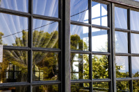 the landscape is reflecting in a wooden lattice window of the elafos hotel on rhodes