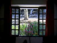 through a wooden lattice window of the elafos hotel on rhodes you see blooming oleander