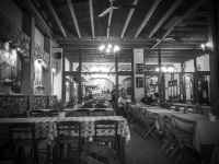 a typical greek tavern with long tables and many chairs in embona on rhodes