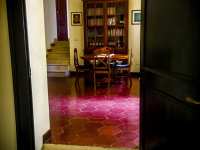 through an open dark wooden door you see the entrance hall of the residenza ducale in bovino in puglia