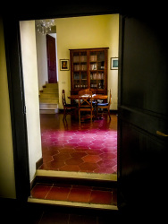 through an open dark wooden door you see the entrance hall of the residenza ducale in bovino in puglia