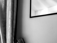 a mirror and a noble floral patterned curtain in a room of the residenza ducale in bovino in puglia, black-and-white