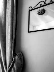 a mirror and a noble floral patterned curtain in a room of the residenza ducale in bovino in puglia, black-and-white