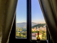 a bottle red wine in front of the window in the residenza ducale in bovino in puglia
