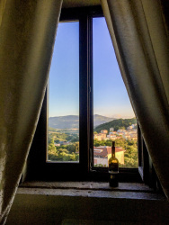 a bottle red wine in front of the window in the residenza ducale in bovino in puglia