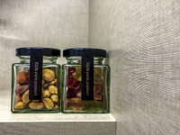 a glass of nuts and a glass of gummy bears in a room of the hotel nh collection köln mediapark in cologne