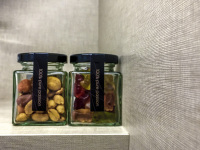 a glass of nuts and a glass of gummy bears in a room of the hotel nh collection köln mediapark in cologne