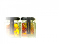 a glass of nuts and a glass of gummy bears in a room of the hotel nh collection köln mediapark in cologne