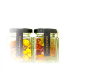 a glass of nuts and a glass of gummy bears in a room of the hotel nh collection köln mediapark in cologne