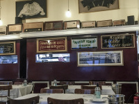 the tavern barbadimos in piraeus with vintage decoration an the cook who looks out of the kitchen