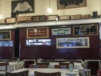 the tavern barbadimos in piraeus with vintage decoration an the cook who looks out of the kitchen