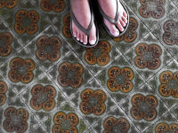 old tiles with green and brown nuances under the feet in the hotel elafos on rhodes