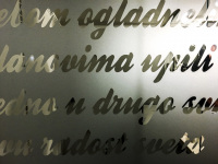 a frosted glass window pane with lettering in serbian in clear glass in the hotel crystal light in nis