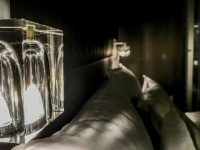 louminous glass bedside lamps and white pillows in a room of the steigenberger airport hotel berlin