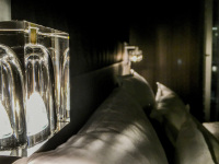 louminous glass bedside lamps and white pillows in a room of the steigenberger airport hotel berlin