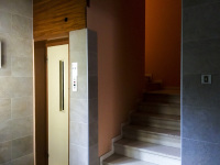 various natural tones in a hallway in a housee in ioannina with stairs and a lift