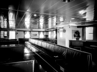 benches in a lounge of an old ferry in greece, black-and-white