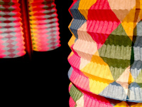 in a black dark room are shining colorful lanterns