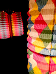 in a black dark room are shining colorful lanterns