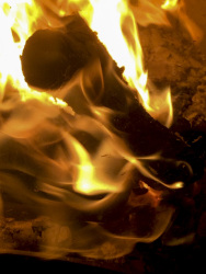 behind a kiln glass is burning a yellow fire