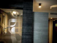 wooden and glass walls in front of a bathroom in the hotel crystal light in nis in serbia