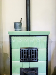 on an old light green oven is standing a metall bucket