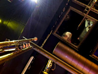 a trumpet and mirrors are hanging on the ceiling in papa joe\'s jazzlokal in cologne