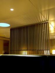wooden elements, leather benches and cozy light in the seat areas of the business lounge of swiss air at the airport of zurich
