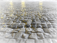 yellow lights are shining on the grey stony mosaik floor of the grandmaster palace in rhodes city