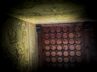 a brown wooden ceiling and a with ornaments painted wall in the grandmaster palace in rhodes city