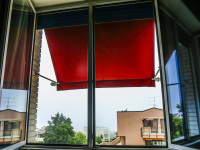 a red awning at the window of a room in the regent boutique hotel & spa in san marino