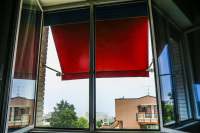 a red awning at the window of a room in the regent boutique hotel & spa in san marino
