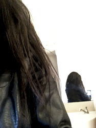 self-portrait in the mirror with leather jacket from behind