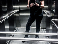 self-portrait in elevator with corona mask