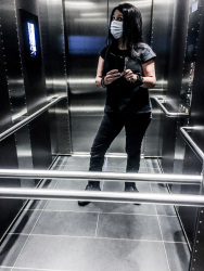 self-portrait in elevator with corona mask