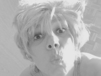 self-portrait with a kiss and a wig with blond short hairs, black-and-white