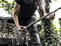 self-portrait while playing a lawn rake like a guitar