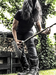 self-portrait while playing a lawn rake like a guitar