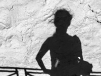 shadow self-portrait with bag at a white wall, black-and-white
